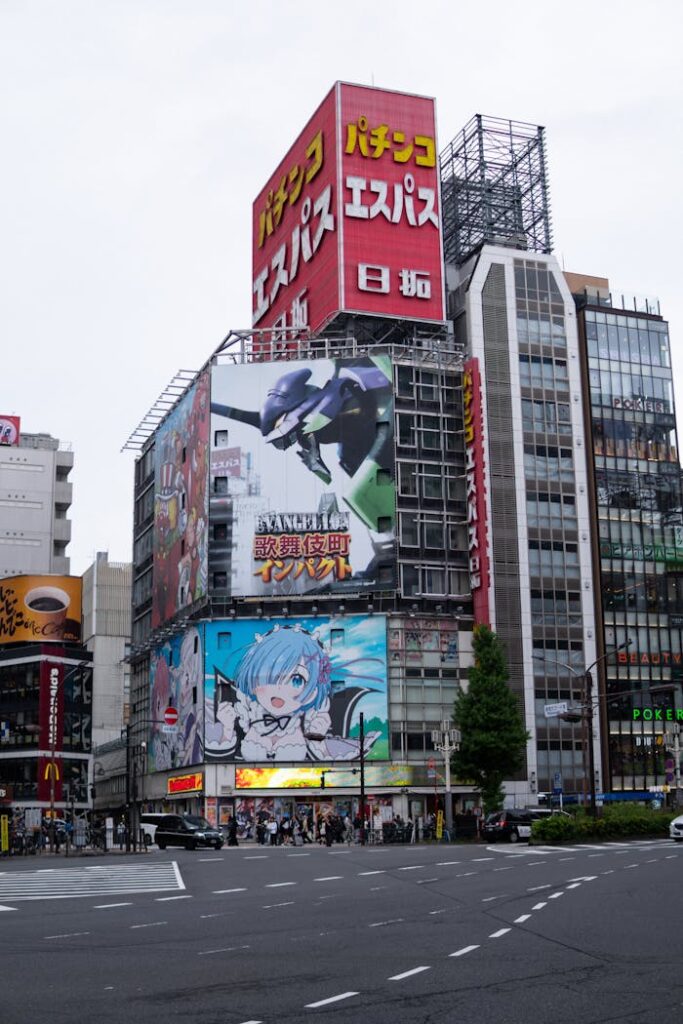 Vibrant Tokyo street featuring large anime billboards and urban architecture.
